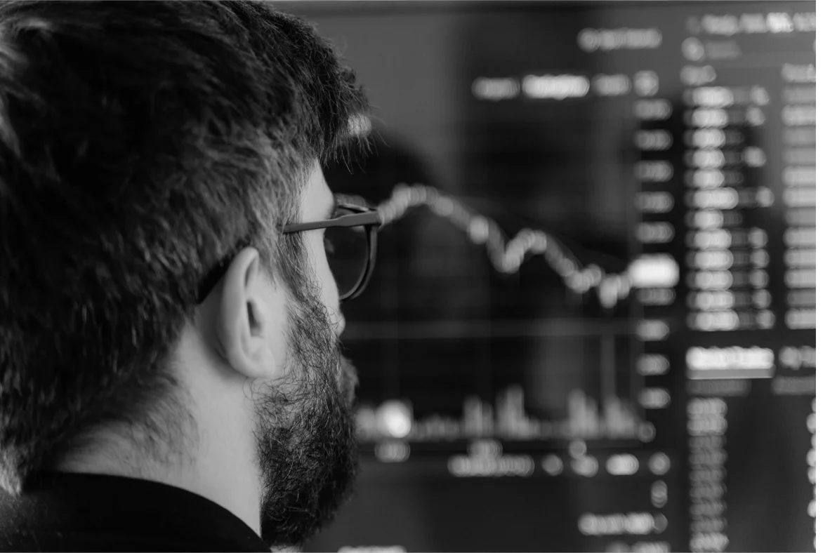 An asset manager looking intently at a financial data screen.